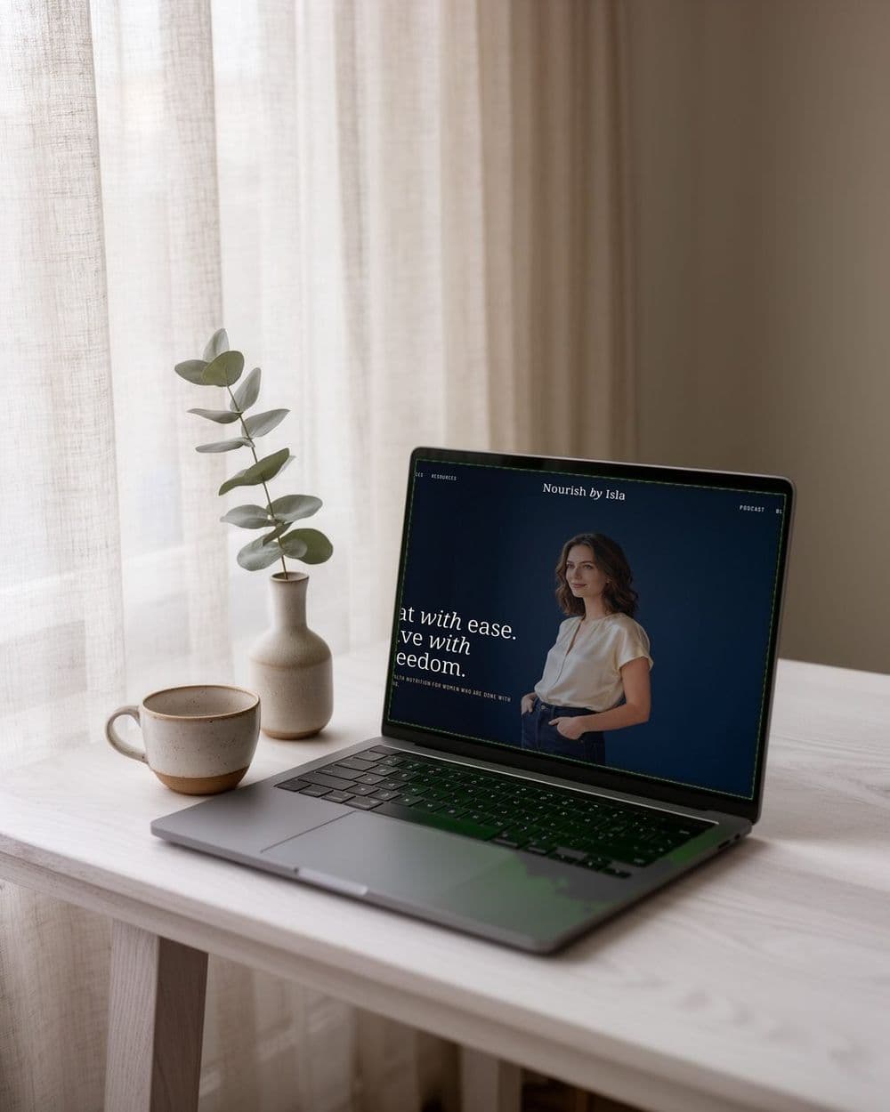 A laptop on a side table showing one of our website designs