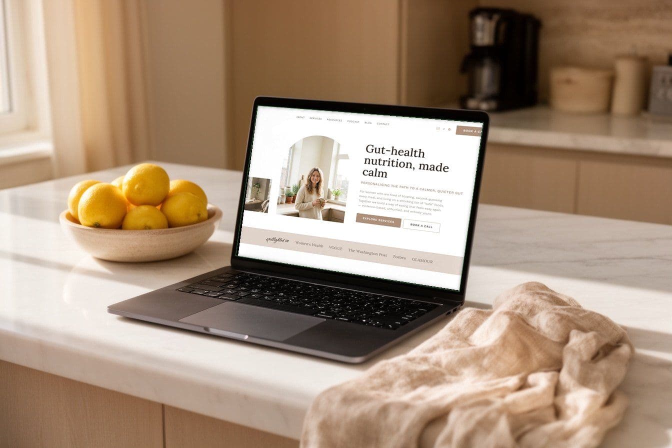 A laptop on a kitchen bench showing one of our website designs